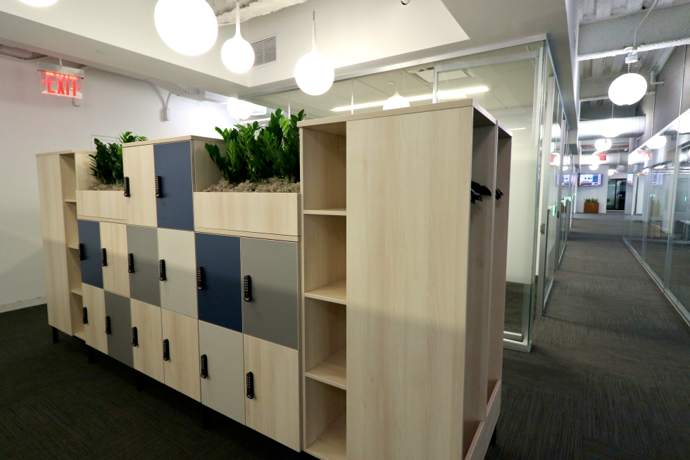  Freestanding lockers and coat storage serve as room dividers and a home for more greenery. 